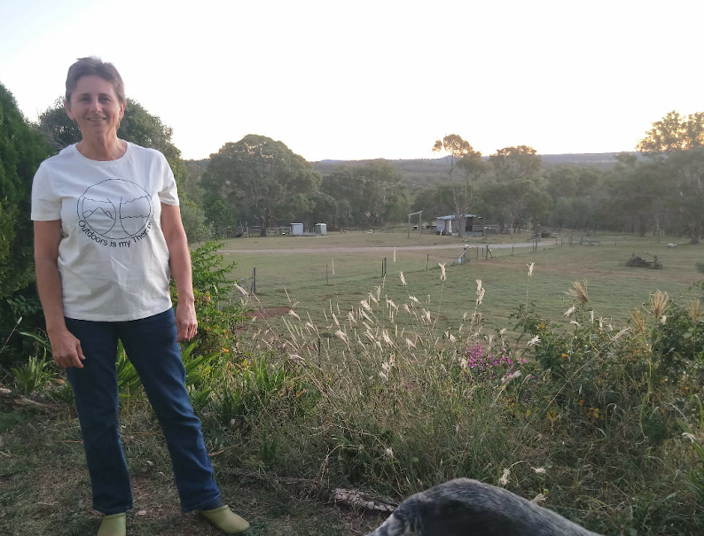 Tania stands in a farm paddock